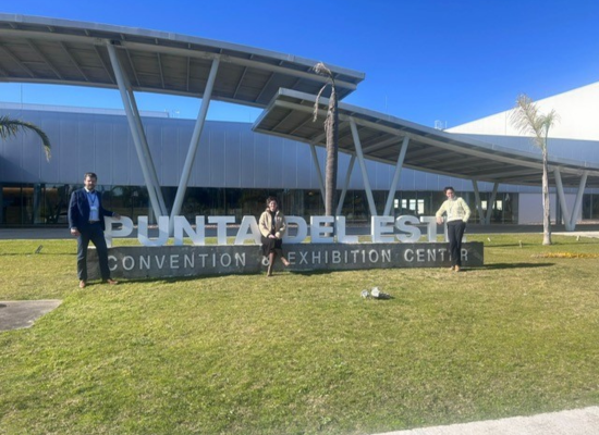 three people standing next to letters saying Punta del Este